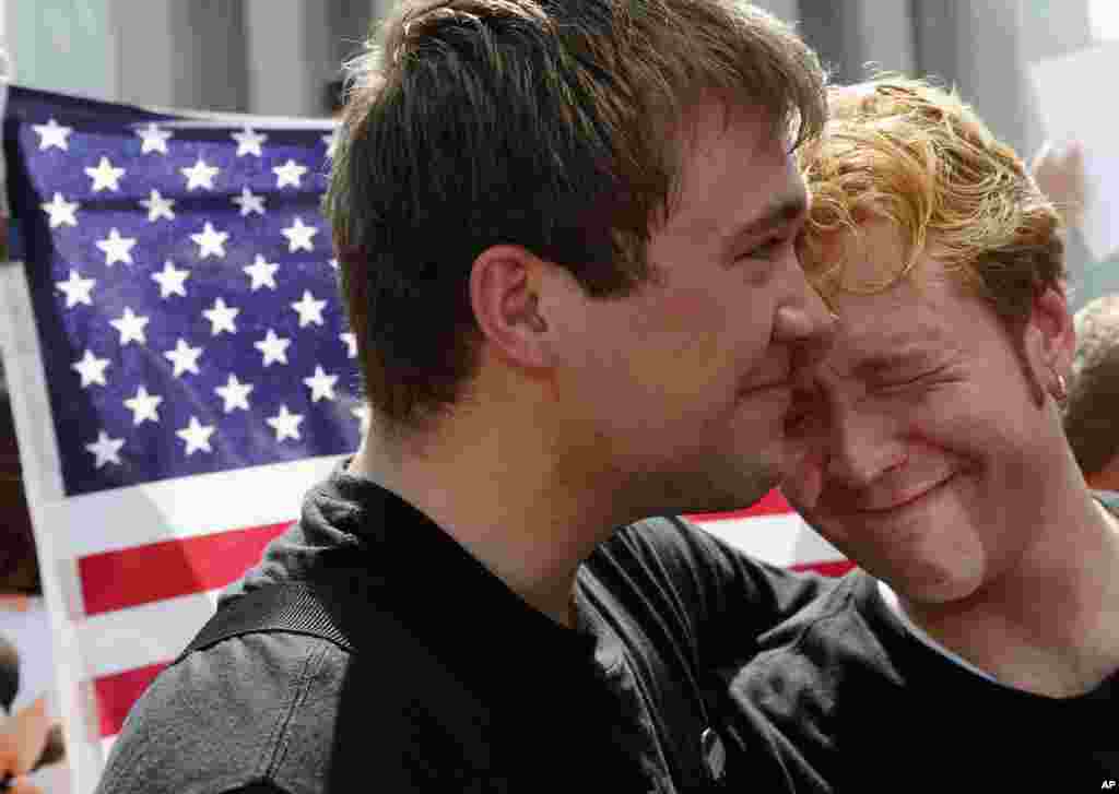 Michael Knaapen, left, and his husband John Becker, right, embrace outside the Supreme Court in Washington, June 26, 2013, after the court cleared the way for same-sex marriage in California.