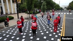 National Nurses United (NNU) holds a protest against working conditions and a gathering to honor the more than 400 registered nurses who have died from COVID-19, outside of the White House in Washington, May 12, 202…