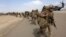 U.S. Marines prepare to depart at the end of operations for Marines and British combat troops in Helmand, Afghanistan, Oct. 27, 2014. 