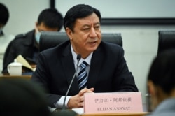 FILE - Elijan Anayat, spokesperson of the Information Office of the People's Government of Xinjiang Uygur Autonomous Region, answers a question at a press conference in Beijing on Jan. 11, 2021.