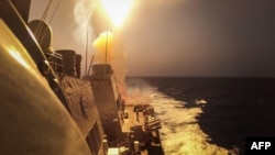 FILE - This U.S. Navy photo taken on Oct. 19, 2023, shows the USS Carney defeating Houthi missiles in the Red Sea. On Nov. 29, the ship shot down a drone launched from areas of Yemen controlled by Houthi militants. U.S. forces also were attacked, by a rocket assault, in Syria.