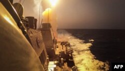 FILE - This handout picture courtesy of the U.S. Navy taken on Oct. 19, 2023, shows the Arleigh Burke-class guided-missile destroyer USS Carney defeating a combination of Houthi missiles and unmanned aerial vehicles in the Red Sea.