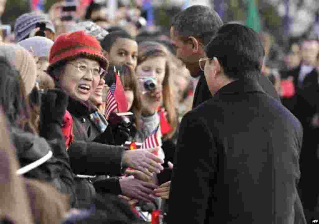 President Barack Obama and China's President Hu Jintao greet guests during a state arrival ceremony at the White House in Washington, Wednesday, Jan. 19, 2011. (AP Photo/J. Scott Applewhite)