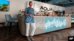 Roia Jabari, managing director of AQUA Water Bar by LUQEL poses at her store in Dubai, United Arab Emirates on July 11, 2023. (AP Photo/Kamran Jebreili)