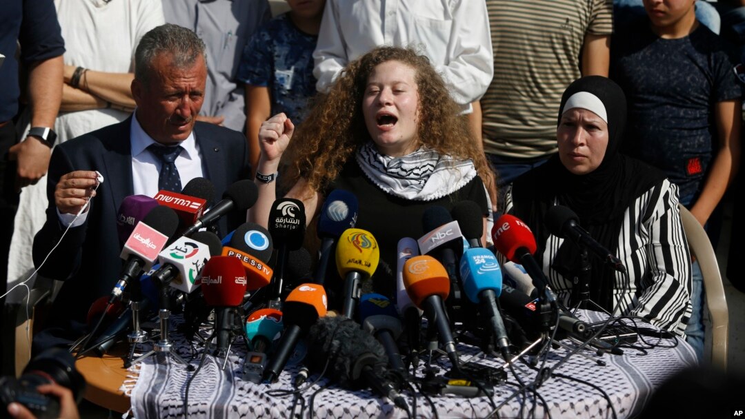 Ahed Tamimi speaks sitting between her father Bassam and mother Nariman during a press conference on the outskirts of the West Bank village of Nabi Saleh near the West Bank city of Ramallah, July 29, 2018.