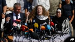 Ahed Tamimi speaks sitting between her father Bassam and mother Nariman during a press conference on the outskirts of the West Bank village of Nabi Saleh near the West Bank city of Ramallah, July 29, 2018. 