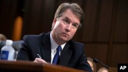 President Donald Trump's Supreme Court nominee, Brett Kavanaugh, takes notes as the Senate Judiciary Committee members make opening statements during his confirmation hearing, on Capitol Hill in Washington, Sept. 4, 2018.