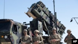 This file photo shows members of the U.S. military with a Patriot missile defense system in 2017. Ukraine says it used a system recently to shoot down a fast Russian missile. (AP Photo/Mindaugas Kulbis, File)