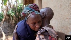 Emelyne Nzeyimana, left, and Prudencienne Namukobwa perform akazehe, a Burundian traditional form of musical greeting performed exclusively by women, outside her home in Ngozi, Burundi, Sept. 20, 2024.