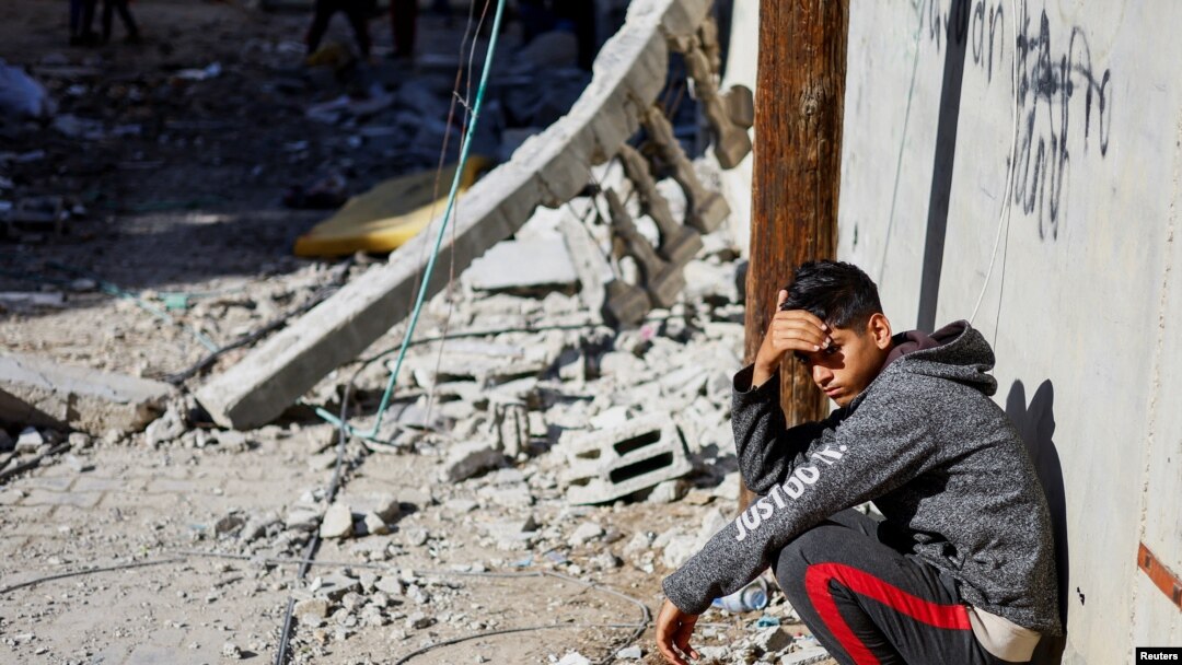 A Palestinian boy reacts near the site of an Israeli strike on a house, in Rafah, in the southern Gaza Strip