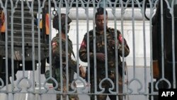 Soldiers keep watch inside the City Hall compound in Yangon on February 1, 2021, as Myanmar's military detained the country's de facto leader Aung San Suu Kyi and the country's president in a coup. (Photo by STR / AFP)