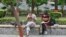FILE - Indian students study inside the Delhi University campus in New Delhi.