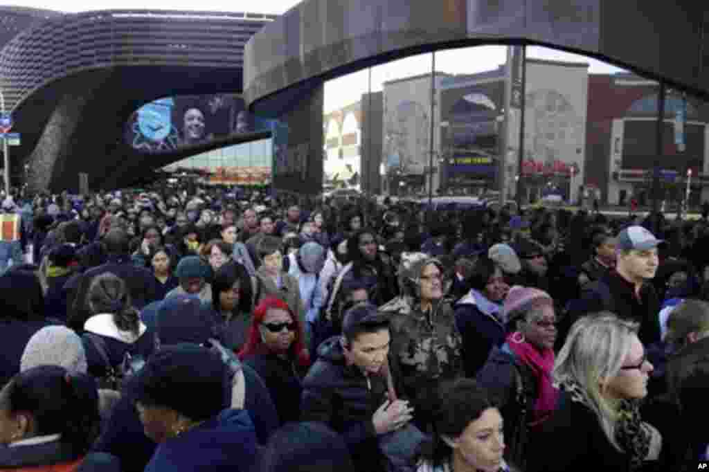 Commuters wait in a line to board buses into Manhattan in front of the Barclays Center in Brooklyn, New York, Thursday, Nov. 1, 2012. The line stretched twice around the arena and commuters reported wait times of one to three hours to get on a bus.