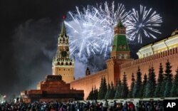 Fireworks explode over the Kremlin during New Year's celebrations in Red Square with the Spasskaya Tower, left, in the background in Moscow, Jan. 1, 2020.