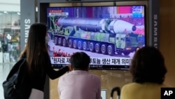 People watch a TV screen showing a file image of a North Korean missile in a military parade during a news program at the Seoul Railway Station in Seoul, South Korea, Monday, Aug. 30, 2021. North Korea appears to have restarted the operation of its…