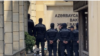 Farid Mehralizada, an economist and journalist for Radio Free Europe/Radio Liberty’s Azerbaijani Service, is guarded by police in this undated photo.