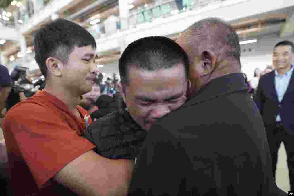 Pongsak Thaenna, center, a Thai hostage who was freed from Hamas, hugs a relative upon arrival at Suvarnabhumi International Airport in Samut Prakarn Province, Thailand.