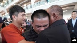 Pongsak Thaenna, center, a Thai hostage who was freed from Hamas, hugs a relative upon arrival at Suvarnabhumi International Airport in Samut Prakarn Province, Thailand.