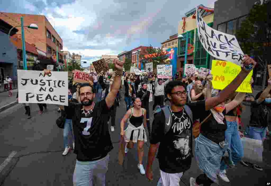 Demonstrators protest the death of George Floyd in downtown Albuquerque, N.M., May 31, 2020.