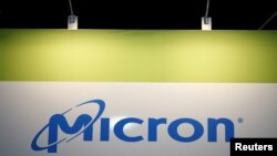 FILE - The logo of U.S. memory chip maker Micron Technology is pictured at its booth at an industrial fair in Frankfurt, Germany, July 14, 2015. 