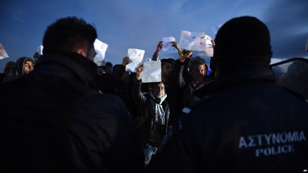 Afghan refugees stage a rally demanding to be allowed by the Greek police to reach the borderline with Macedonia, near the northern Greek village of Idomeni, on Sunday, Feb. 21, 2016.