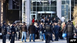 People arrive at a courthouse to attend the trial of eighteen students and a lecturer allegedly involved in a banned LGBTI pride event, in Ankara, Turkey, Nov. 12, 2019. 