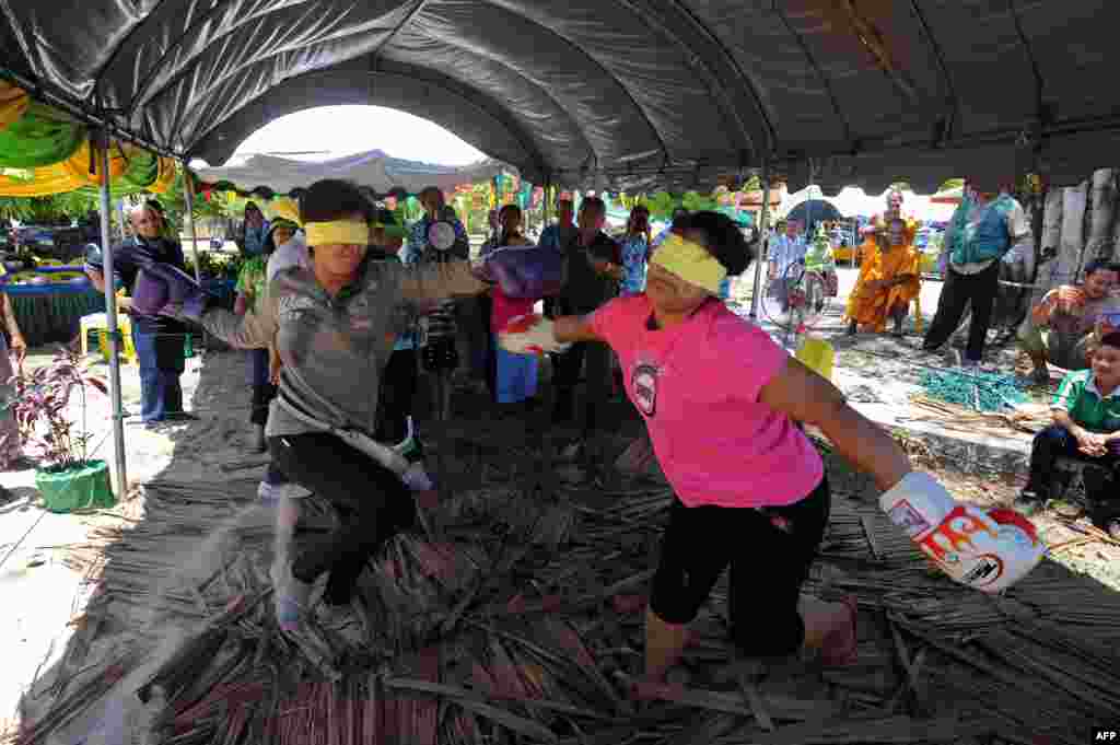 Thai Buddhist women take part in a blindfolded boxing bout as part of celebrations of the Songkran festival marking the Thai new year in Thailand&#39;s southern province of Narathiwat. The Thai new year falls on April 13. &nbsp;