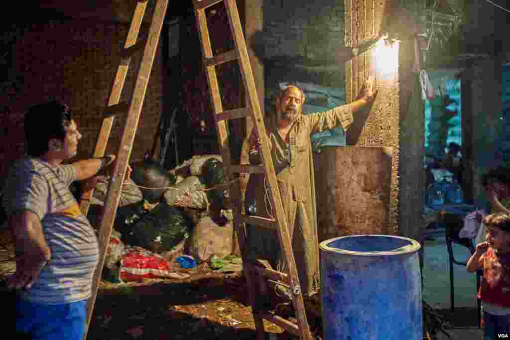 With rates continuing to rise, Egyptian families often reduce costs by limiting lighting to one bulb for an entire room. (H. Elrasam/VOA)