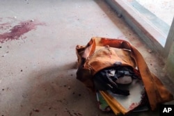 FILE - A school bag lies next to dried blood stains on the floor of a middle school in Let Yet Kone village in Tabayin township in the Sagaing region of Myanmar on Saturday, Sept. 17, 2022, the day after an air strike hit the school.