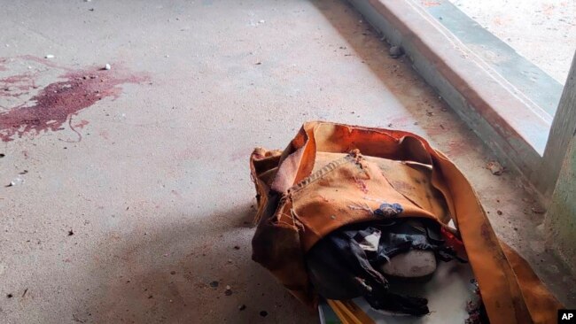 FILE - A school bag lies next to dried blood stains on the floor of a middle school in Let Yet Kone village in Tabayin township in the Sagaing region of Myanmar, Sept. 17, 2022, the day after an air strike hit the school.