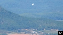 North Korean balloons are seen from the Unification Observation Post in Paju, South Korea, near the border with North Korea, Oct. 4, 2024. 