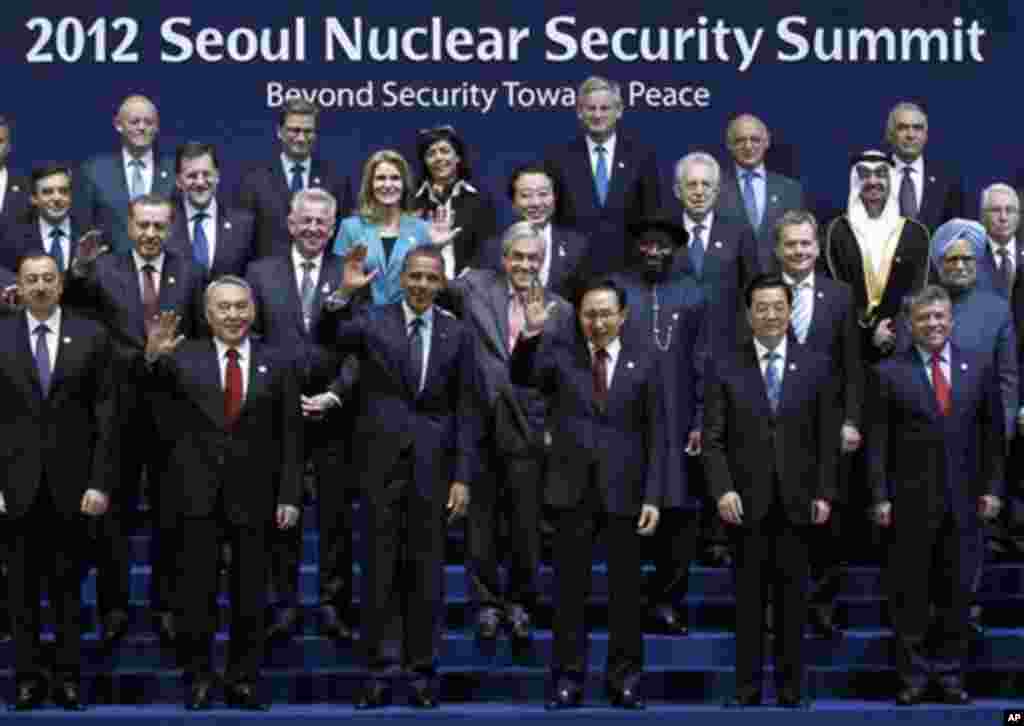 U.S. President Barack Obama, third from left in front row, and South Korean President Lee Myung-bak, fourth from left in front row, wave along with other leaders during a group photo session for the Nuclear Security Summit in Seoul, South Korea, Tuesday,