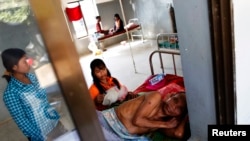 A malaria patient is comforted in the only hospital in Pailin, western Cambodia. (File)