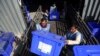 Afghan election workers load ballot boxes and other election materials on a truck for distribution at the Independent Election Commission compound, in Kabul, Afghanistan, Sept. 23, 2019. The election is Saturday.