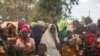 Displaced women attend a meeting at Centro Agrario de Napala where hundreds of displaced people are sheltered, fleeing attacks by armed insurgents in different areas of the province of Cabo Delgado, in northern Mozambique, Dec. 11, 2020. 