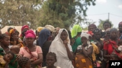 Displaced women attend a meeting at the Centro Agrrio de Napala where hundreds of displaced people are sheltered, fleeing attacks by armed insurgents in different areas of the province of Cabo Delgado, in northern Mozambique, Dec. 11, 2020. 