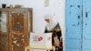 A woman votes at a polling station during the presidential election in Tunis, Oct. 6, 2024. 