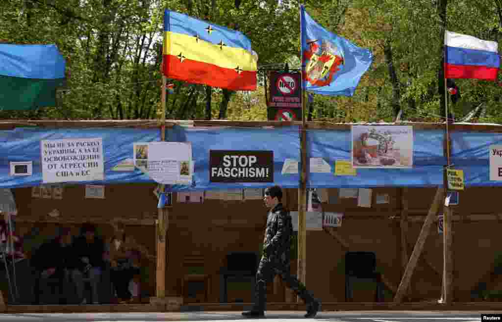 A Pro-Russian supporter walks at the seized office of the SBU state security service in Luhansk, eastern Ukraine, April 24, 2014.