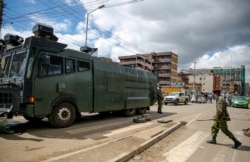 A police water cannon truck blocks a street to prevent residents from leaving the Eastleigh area of Nairobi, May 7, 2020.