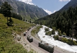 FILE - An Indian Army convoy moves along a highway leading to Ladakh, at Gagangeer in Kashmir's Ganderbal district, June 18, 2020.
