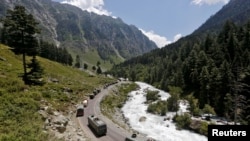 FILE - An Indian Army convoy moves along a highway leading to Ladakh, at Gagangeer in Kashmir's Ganderbal district, June 18, 2020. 