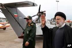 FILE - In this photo released by the Iranian Presidency Office, President Ebrahim Raisi visits an exhibition of the Revolutionary Guard navy capabilities in the southern port city of Bandar Abbas, Iran, February 2, 2024