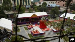 A view from barbed wire to Memorial during its opening ceremony in Tuol Sleng Genocide Museum in Phnom Penh, Cambodia, Thursday, March 26, 2015. The memorial built at Toul Sleng Genocide Museum to remember at least 12,000 people tortured and killed there during the radical Khmer Rouge regime, has been official inaugurated Thursday. (AP Photo/Heng Sinith) 