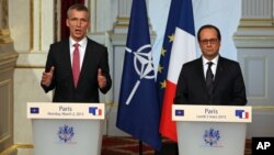 NATO Secretary-General Jens Stoltenberg of Norway, left, speaks during a joint news conference with French President Francois Hollande, after their meeting at the Elysee Palace in Paris, March 2, 2015.