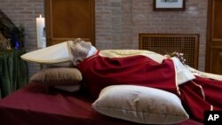 In this image released on Jan. 1, 2023, by the Vatican Media news service, late Pope Emeritus Benedict XVI is laid out in state in the chapel of the monastery 'Mater Ecclesiae' where he mostly lived after retiring.