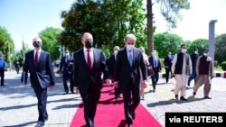Russia's Foreign Minister Sergey Lavrov, left, walks with his Pakistani counterpart Shah Mehmood Qureshi on his arrival at the Ministry of Foreign Affairs in Islamabad, Pakistan, April 7, 2021. (Ministry of Foreign Affairs/Handout via Reuters)