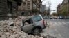 A car is crushed by falling debris after an earthquake in Zagreb, Croatia, March 22, 2020. 