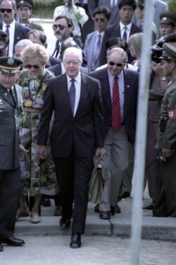 FILE - Former U.S. President Jimmy Carter crosses the military demarcation line in Panmunjom from North to South Korea, June 18, 1994.