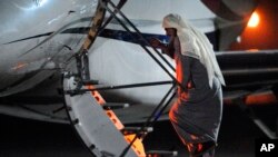 In this photo released by Ministry of Defense, Radical Muslim preacher Abu Qatada boards a private flight bound for Jordan, at RAF Northolt in London, July 7, 2013.