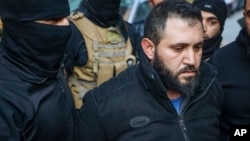 Monzer Al-Jazairi, an alleged former operative with the military security before the fall of Bashar al-Assad, is arrested by security forces in Tadamon, a suburb of Damascus, Syria, Feb. 17, 2025.